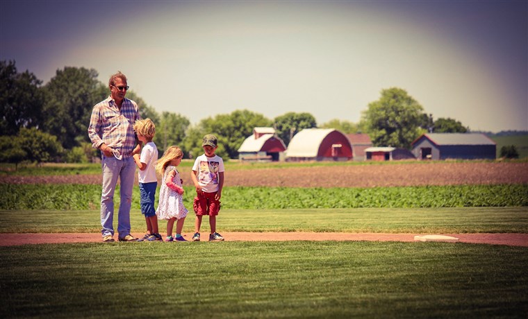 كيفن Costner and his three children walk the bases.
