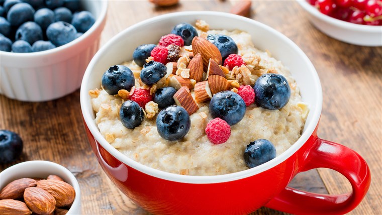 Haferflocken porridge with fruits and nuts for healthy breakfast