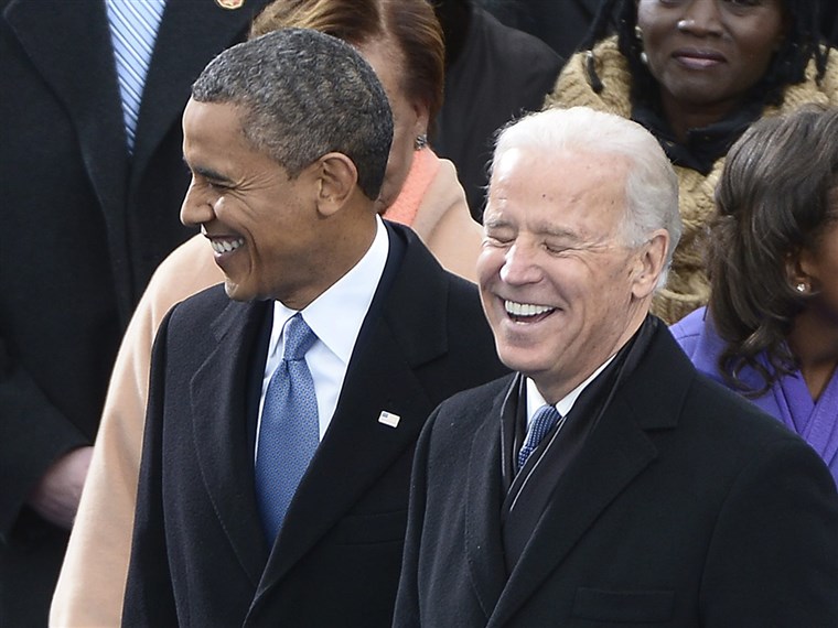 بايدن shares a laugh with President Obama during the inauguration ceremony on the West Front of the US Capitol before Obama is ceremonially sworn in for a second term as the 44th President of the United States.