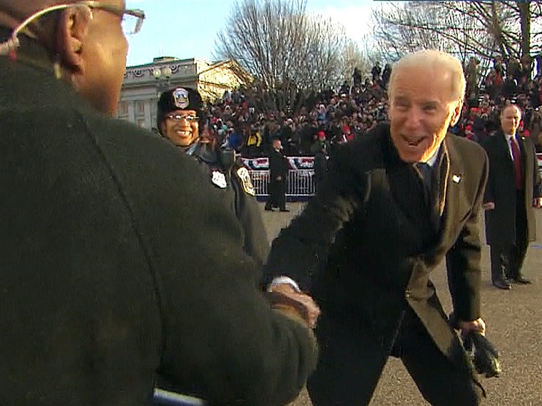 نائب President Joe Biden shakes hands with Al Roker during the inauguration parade.