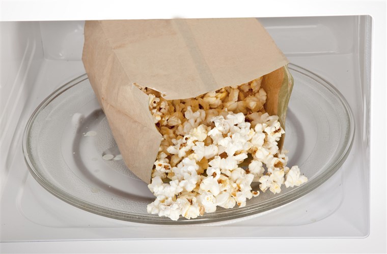 Popcorn cooked in a microwave oven still in the bag.; Shutterstock ID 62663599; PO: today.com