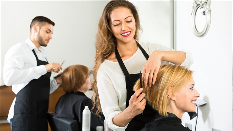 باسم client sitting in a hair salon while hairdresser is combing her hair. Focus on client; Shutterstock ID 301639736; PO: TODAY.com