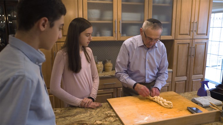 نات Shaffir makes challah bread with two of his 12 grandchildren, 17-year-old Benji Wilbur and 14-year-old Kira Wilbur. 