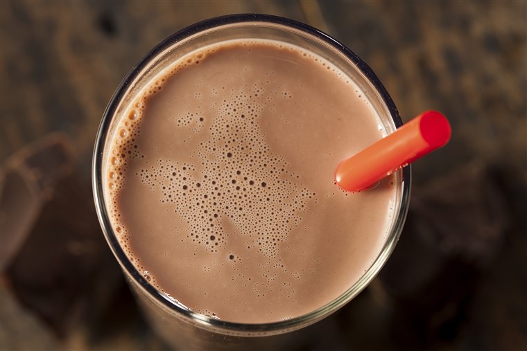 Schokolade milk on a glass with red straw