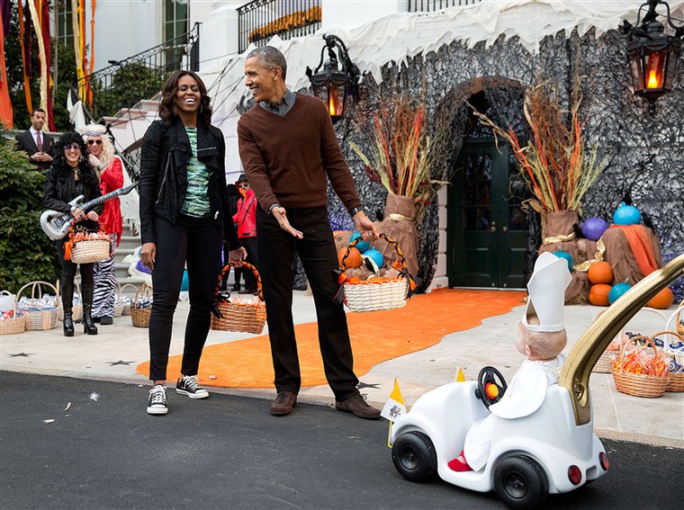 Das president and first lady react to a child in a pope costume and mini popemobile as they welcomed children during a Halloween event on the South Lawn of the White House on Oct. 30, 2015.