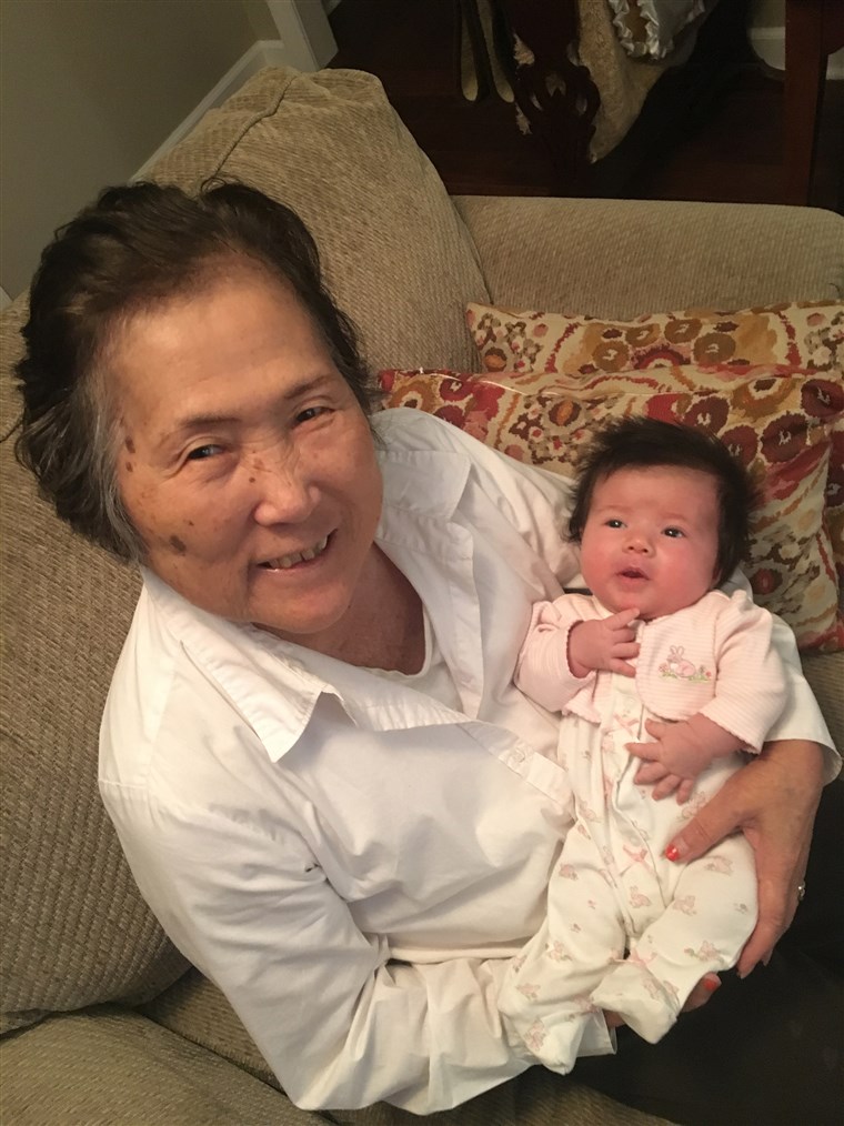 老年痴呆症's patient Setsuko Harmon cradles her granddaughter Sadie.