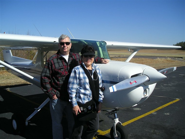 Bob and Setsuko Harmon next to one of the Cessna plans Setsuko used to fly.