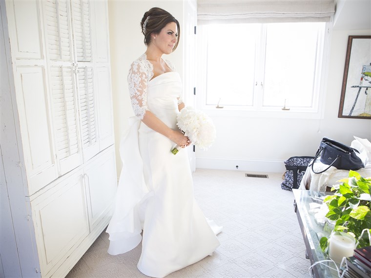 Bobbie Thomas poses in her Le Spose di Gio gown before the start of the wedding.