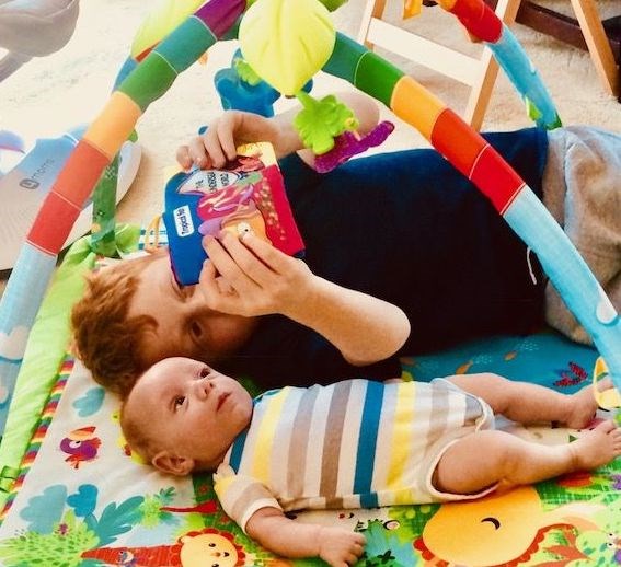 Mikey loves to sing and read books to his baby brother.