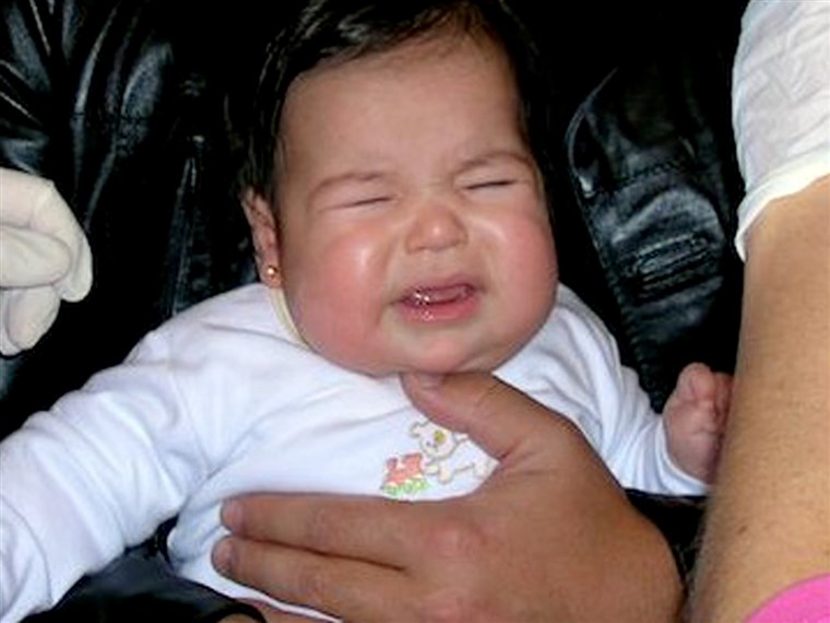 روكسانا Soto's daughter gets her ears pierced at four months old.