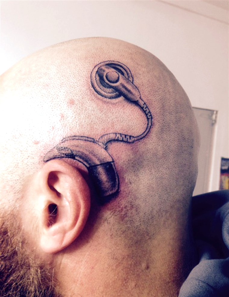 الجديد Zealand dad gets tattoo of a cochlear implant, to match the one his daughter was about get.