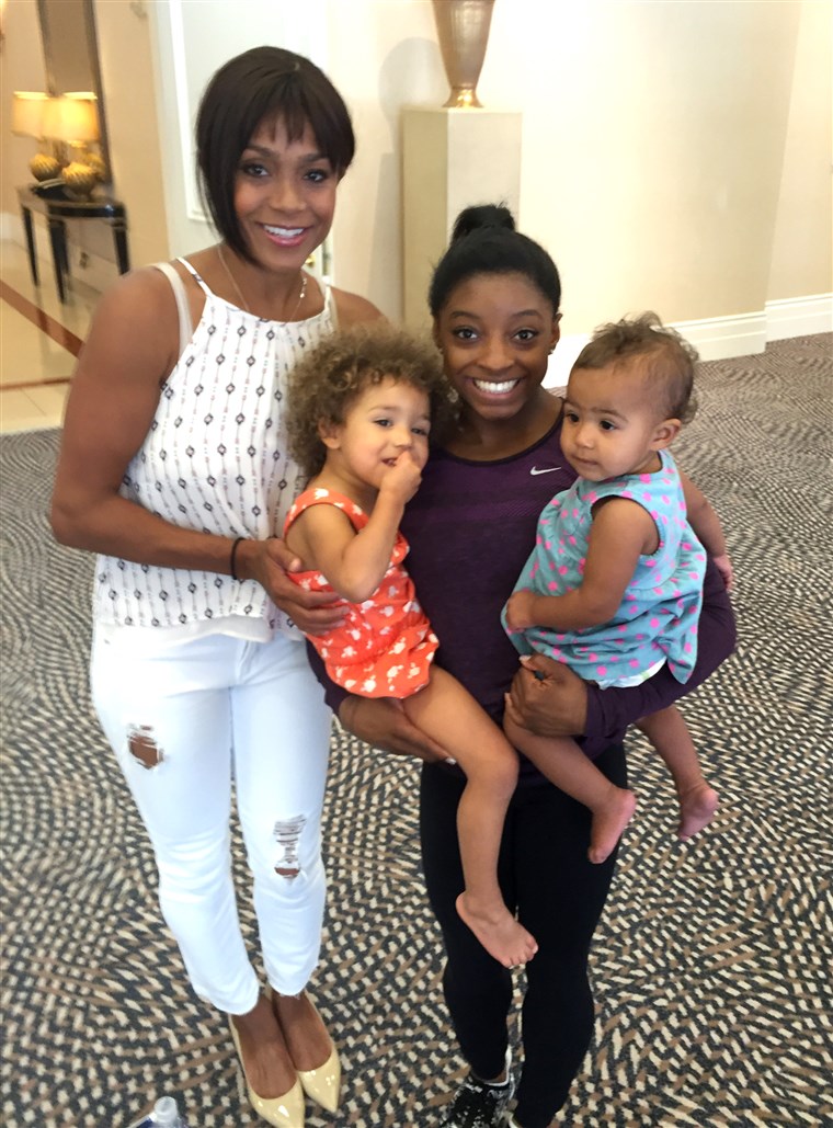 Dawes and her daughters pose with gymnast Simone Biles.