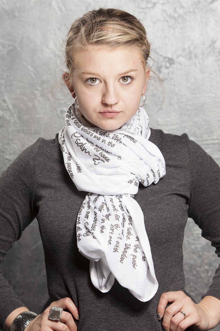 ا model wears a scarf from the God Inspired Fashion collection.