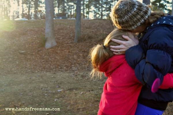 Mama hugging child before school