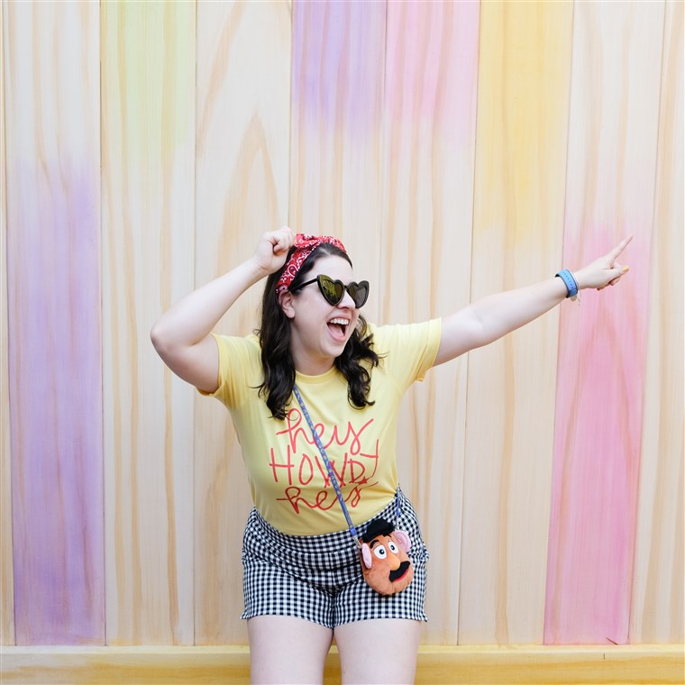 Nicole White poses with the Popsicle Stick Wall, found in Toy Story Land at Hollywood Studios.