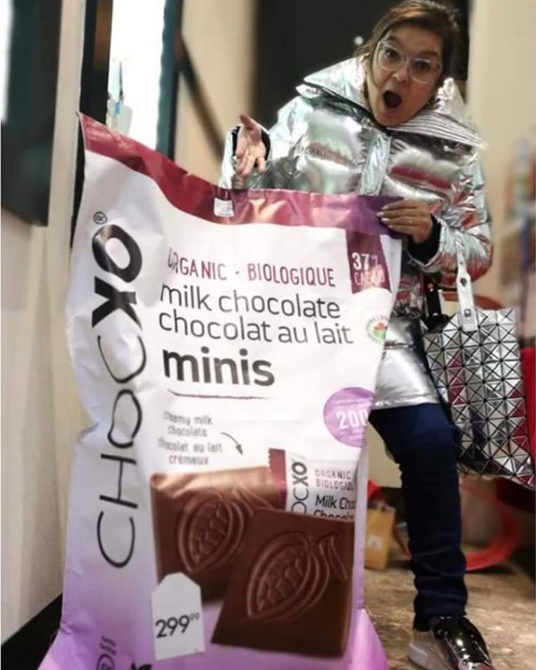 女人 behind a giant bag of ChocXO chocolates