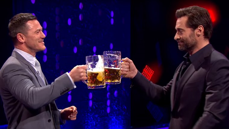 Hugh Jackman and Luke Evans raise a glass to Gaston